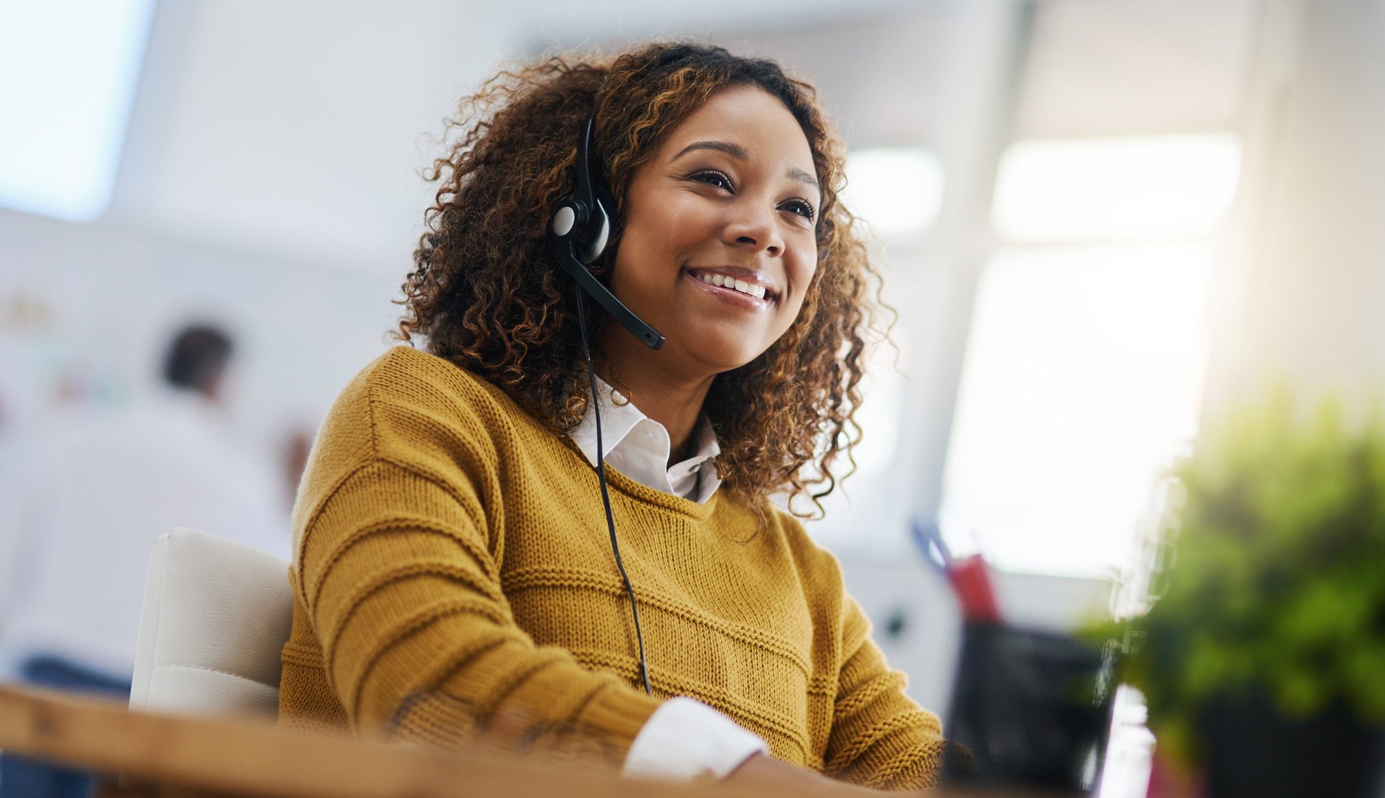 An interpreter smiles as she interprets for a call.