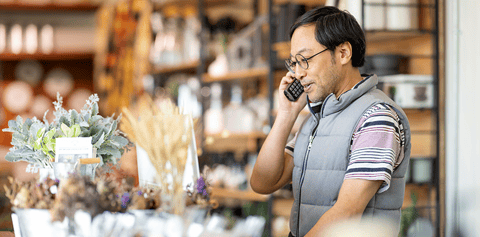 A man answers a call with an interpreter already on the line to help his customer.