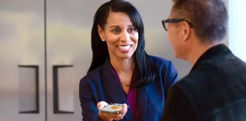 A man and woman speak with the help of the interpreting app.