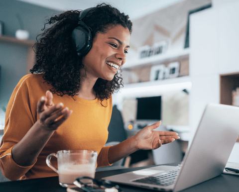 A woman leads a virtual meeting with the help of an interpreter.