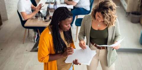 Two women look at a translated document together