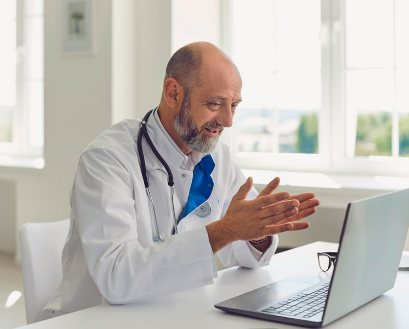 A doctor reviews medical records that need to be translated online.