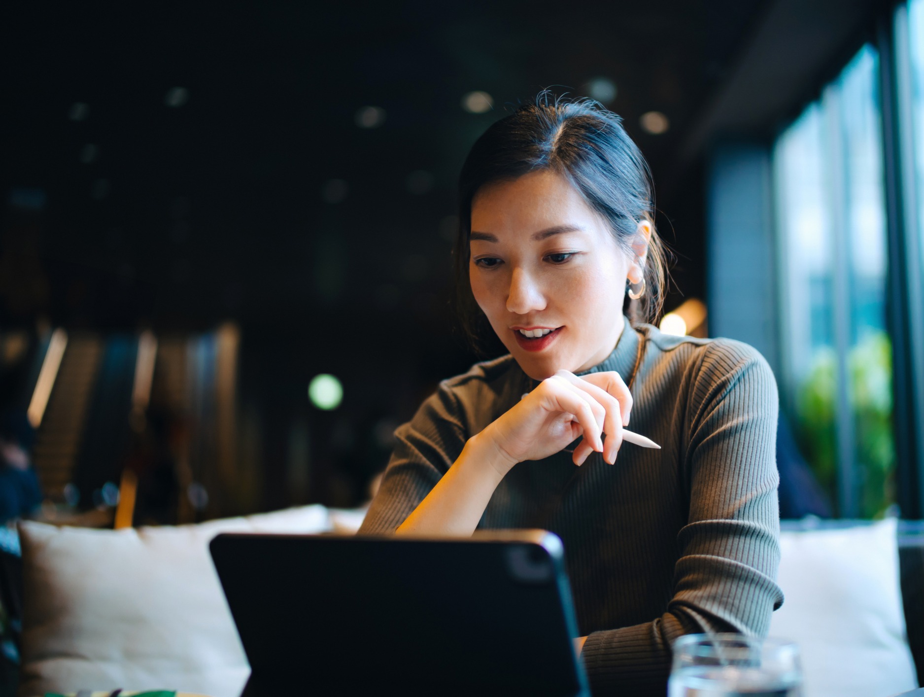 A linguist reviews a machine-translated document on her computer