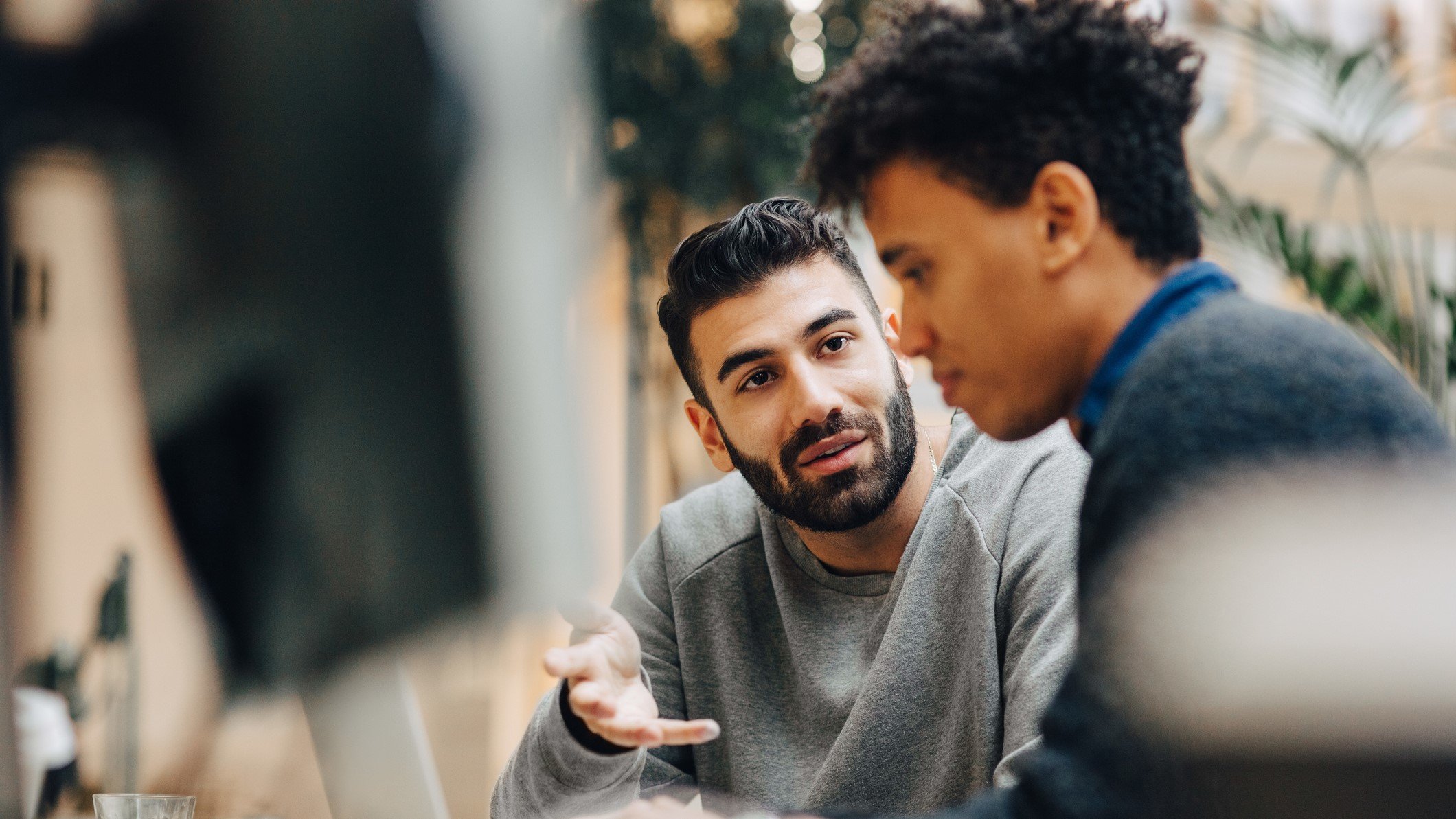 Two men discuss a translation project.
