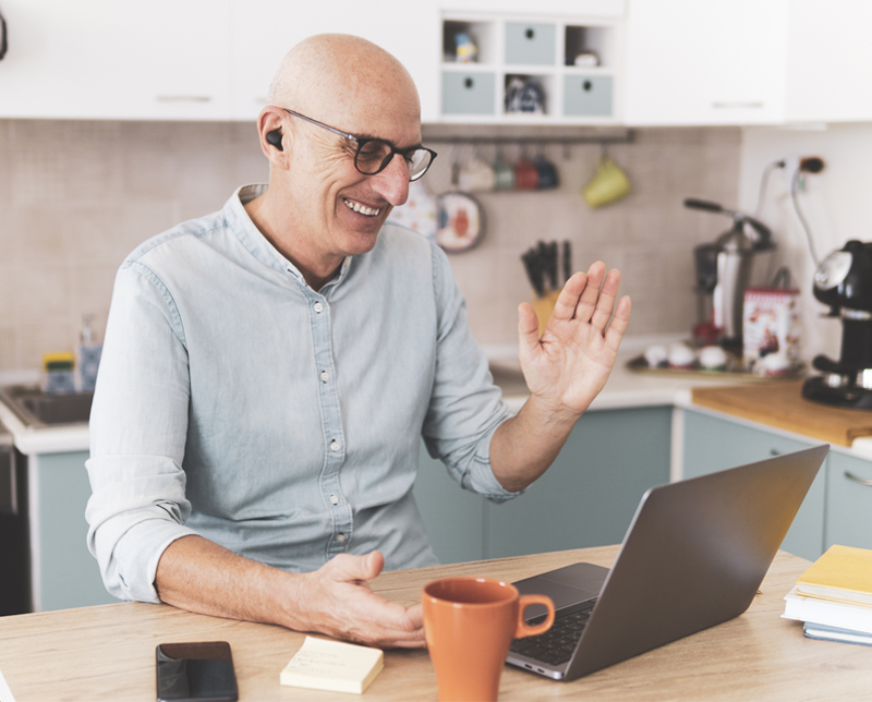 A linguist greets a customer during a virtual meeting