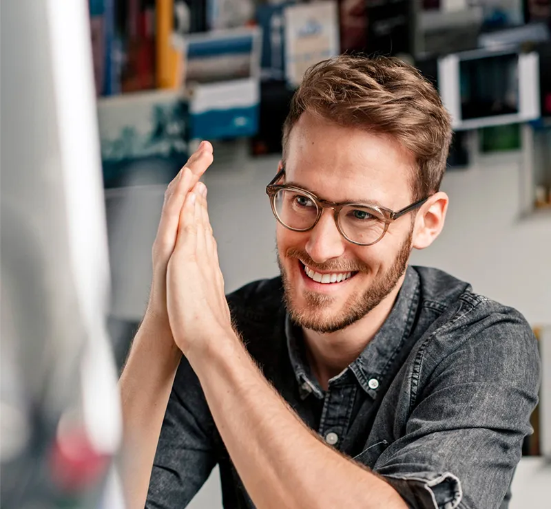 A man looks satisfied as he looks at a project online.