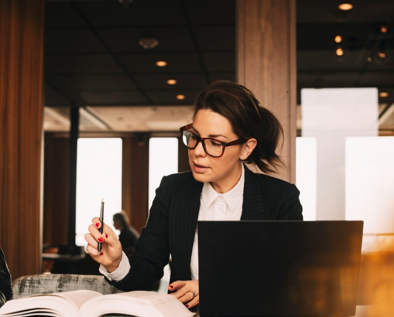 A lawyer works on her computer on some legal documentation that will need to be translated.